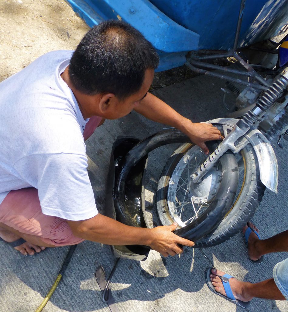 Having a flat tire with your tricycle, Moalboal - Phillipines