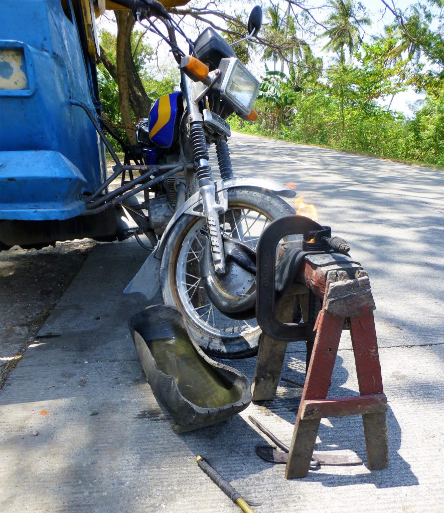 Having a flat tire with your tricycle, Moalboal - Phillipines